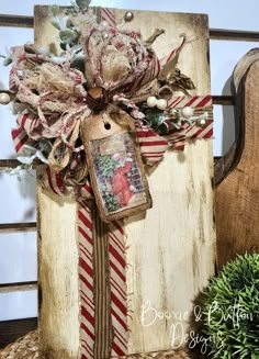 an old wooden box with a christmas decoration on it and a tag hanging from the front