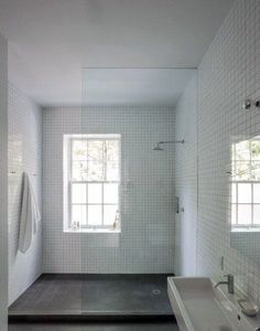 a bathroom with a sink, mirror and shower stall