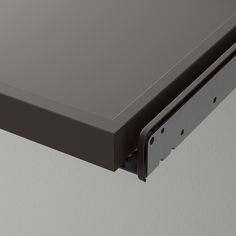 a close up of a metal shelf with a drawer on the bottom and an opening in the middle