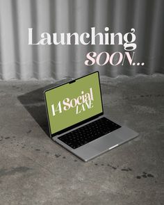 an open laptop computer sitting on top of a cement floor with the words launching soon