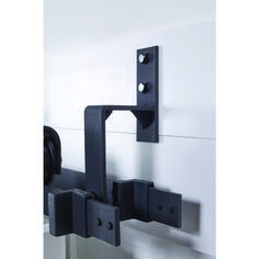 a pair of black brackets mounted to the side of a wall