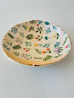 a white bowl with floral designs on it