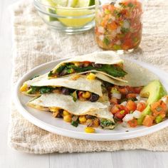 a white plate topped with tacos and vegetables