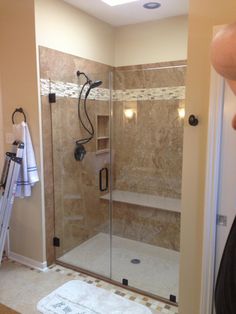 a walk in shower sitting next to a bathroom sink