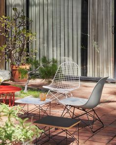 several chairs and tables are sitting on the brick patio in front of an outdoor building