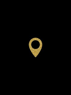 a gold pin on a black background