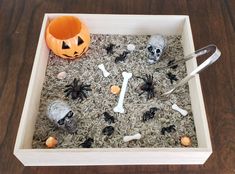 a tray filled with halloween decorations on top of a wooden table