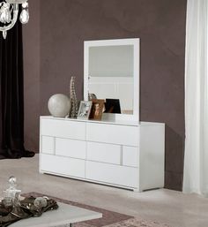 a white dresser and mirror in a room