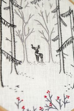 a cross stitch pattern with a moose in the woods