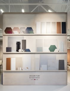 a display case filled with lots of different types of furniture and decor on top of white walls