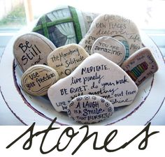 some rocks with writing on them in a bowl