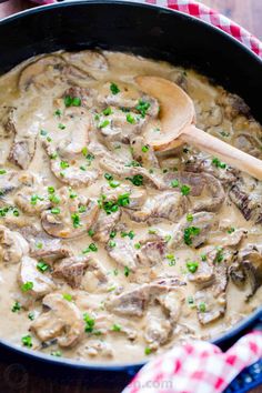 a skillet filled with mushrooms and gravy