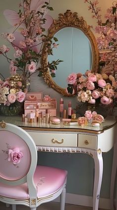 a vanity with pink flowers on it and a mirror in the corner next to it