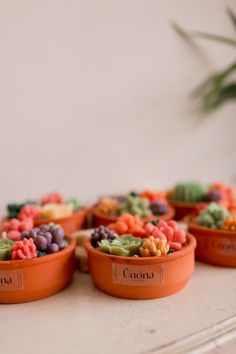 small pots filled with different types of candy