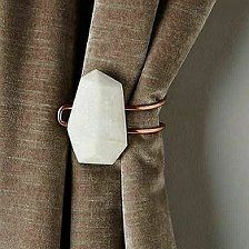 a close up of a curtain with a tie bar