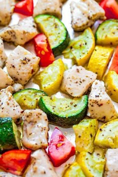 chicken and zucchini kabobs on a white platter