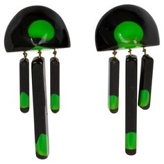 These stunning modernist Lucite or resin dangling clip-on earrings feature a carved dimensional geometric shape with a black Lucite background topped with green gumdrop inclusions embedded in a yellow apple-juice-colored Lucite. There is no visible designer's mark. Measurements: 1.38 in wide (3.4 cm) x 3.19 in high (8 cm). Yellow Apple, Gum Drops, Apple Juice, Antique Earrings, Maker's Mark, Clip Earrings, Makers Mark, Geometric Shapes, Costume Jewelry