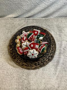 a basket filled with lots of decorated cookies on top of a white tablecloth covered floor