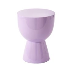 a purple vase sitting on top of a white table