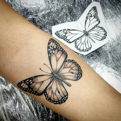 a butterfly tattoo is shown on the arm and leg, with two butterflies in the background