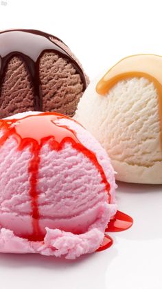 three different types of ice cream on a white surface