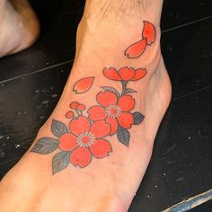 a person with a flower tattoo on their foot