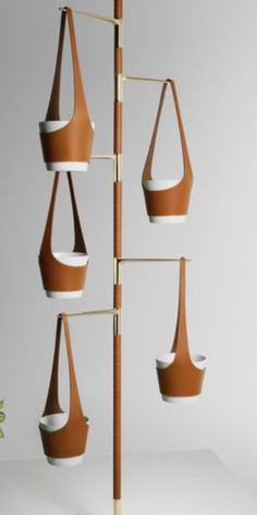 the hanging planter is made out of wood and has four pots on each side