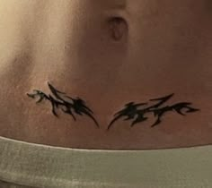 a woman's stomach with black ink on it