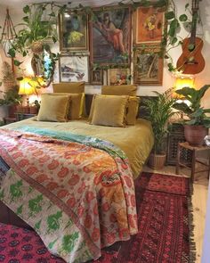 a bed with lots of plants and pictures on the wall