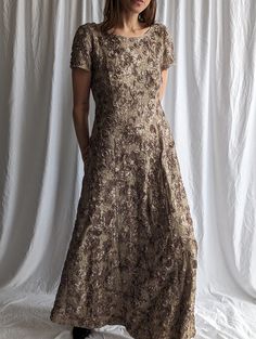 Catch everyone's eye in this stunning sequined floral lace maxi dress!  - Elegant handmade rose embroidery adds shimmering accents  - Flattering crew neck and plunge back highlight your silhouette - Short sleeves and ankle-grazing length keep you comfortable - Inner lining and back zip closure ensure a perfect, secure fit This exquisite lace fabric dress makes a jaw-dropping statement for any special occasion. The intricate floral sequin details give a touch of luxury while the classic maxi silh Fitted Lace Maxi Dress With Short Sleeves, Embroidered Lace Dress For Evening, Evening Lace Maxi Dress With Sequins, Elegant Embroidered Lace Maxi Dress, Short Sleeve Sequined Maxi Dress For Wedding, Spring Fitted Maxi Dress For Mother Of The Bride, Festive Fitted Maxi Dress With Short Sleeves, Fitted Maxi Dress With Short Sleeves For Festive Occasions, Festive Fitted Short Sleeve Maxi Dress