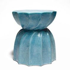 a blue vase sitting on top of a white table