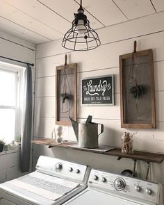 a white washer and dryer in a room with wood paneling on the walls