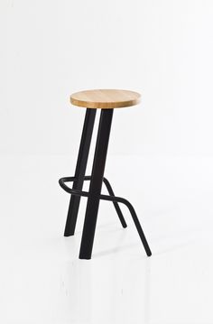 a wooden stool with black metal legs and a wood seat on the backrest, against a white background