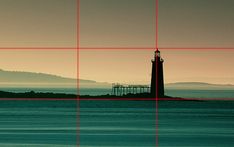 an image of a lighthouse in the middle of water with red lines going across it