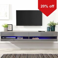 an entertainment center with a large tv on it's side and a red sale sign over the top that says 20 % off