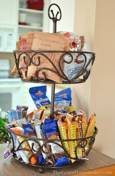 a wire basket filled with snacks on top of a table next to a countertop