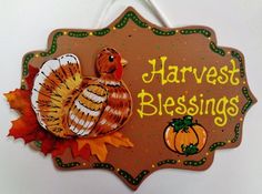 a wooden sign that says harvest blessing with a turkey and pumpkins on the front