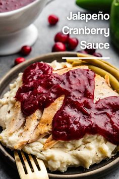 A plate filled with mashed potatoes topped with slices of turkey topped with jalapeno cranberry sauce, with a fork set on the bottom edge of the plate. Cranberry Salad