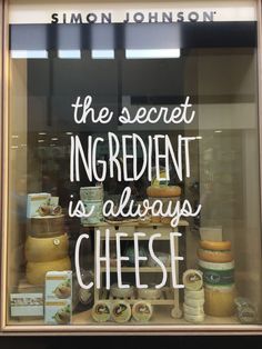 there is a sign in the window that says, the secret ingredient is always cheese