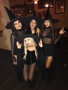 four women dressed up as witches posing for the camera