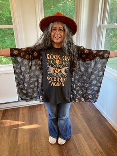 a woman wearing a t - shirt that says rock on and has her arms spread out