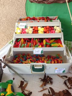 three bins filled with different types of candies on top of a white table