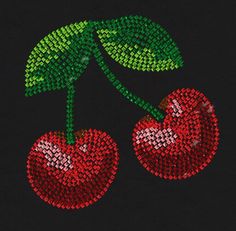 two cherries on a black background with green leaves and red dots in the middle