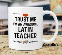 a white coffee mug with the words trust me i'm an awesome latin teacher