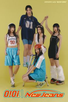 the group of young women are posing together for a photo in front of a yellow background