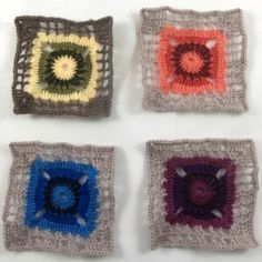 four square crocheted squares with different colors and designs on them, all arranged in the same pattern