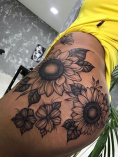 a woman's thigh with sunflowers on it