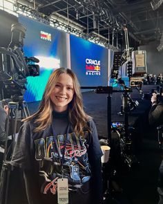 a woman standing in front of a camera