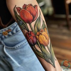 a woman's arm with flowers on it