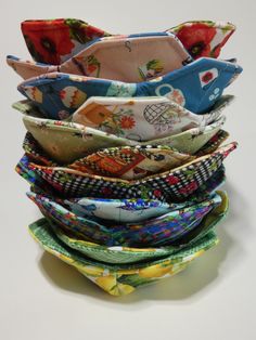 a stack of cloth covered bowls sitting on top of each other